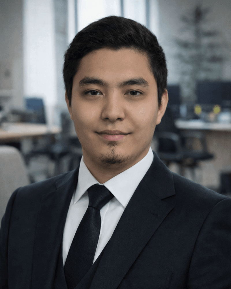 Professional portrait of Slavic man in his 30s with short brown hair wearing black shirt in technology workspace with monitors in background